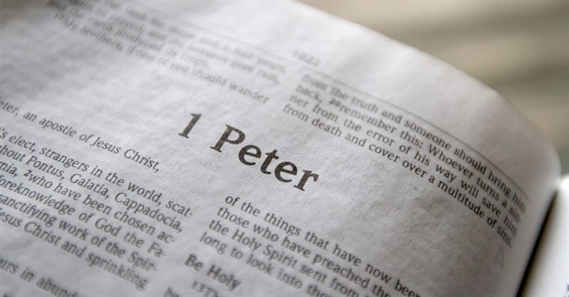 An open Bible showing the first page of the Book of 1 Peter